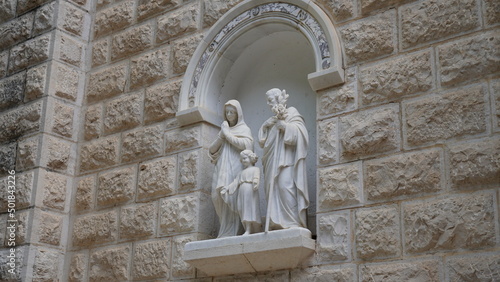 Sculpture of Joseph, Mary and Jesus statues in a niche wall at St. Joseph`s Church, in the old city of Nazareth in Israel photo