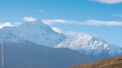 Zoom in Panoramic sunrise time lapse very beautiful nature of mountain peaks,Kazbek mountain , Northern Ossetia - Alania, Dargavs, Caucasus, Russia , moving clouds
