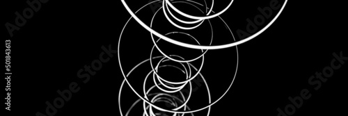 blurred hanging lamp bulb in the form of rings. blur abstract lighting modern pendant electricity round lamps chandelier glowing gray dim light inside a room. tinted in black and white. banner