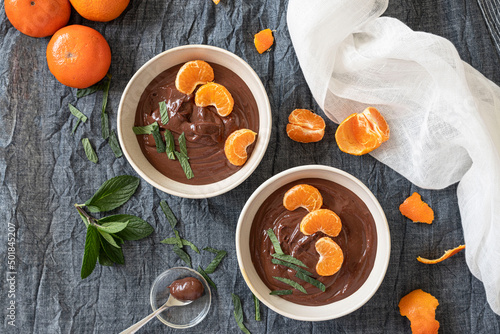 Chocolate cream in bowls with oranges and mint leaves