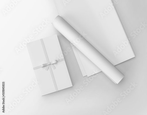 White plain packed gift box with ribbon and wrapping rolled and folded paper sheet 