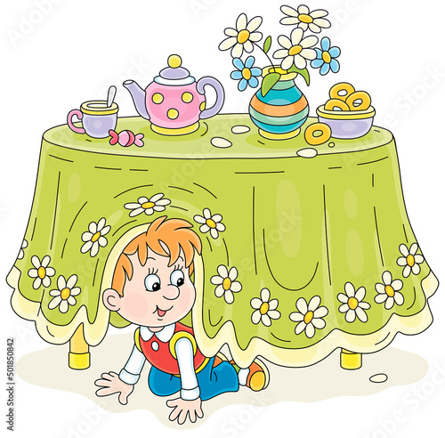 Little boy playing hide and seek under a table with a beautiful tablecloth and a tea set with bagels in a kitchen, vector cartoon illustrations isolated on a white background