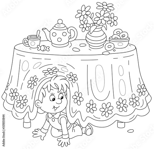 Little boy playing hide and seek under a table with a beautiful tablecloth and a tea set with bagels in a kitchen, black and white outline vector cartoon illustration for a coloring book