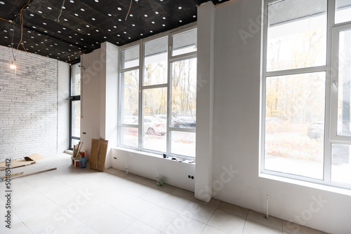 renovated room with shopping window - empty store shop with wooden floor and white walls