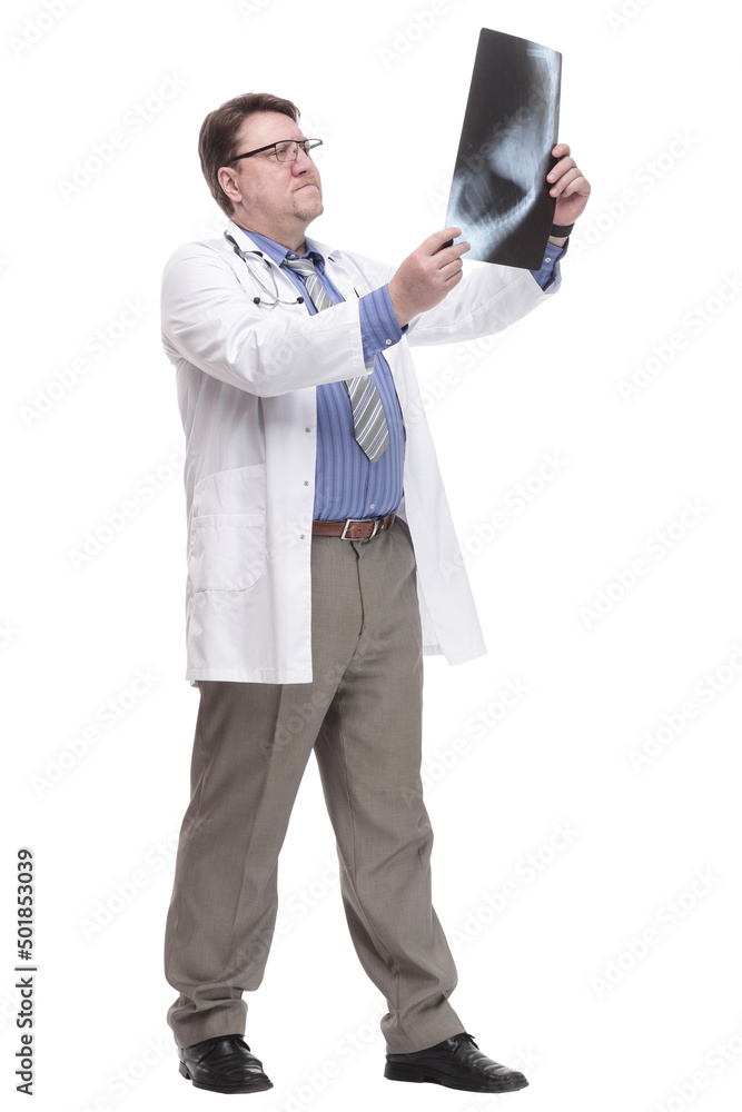 in full growth. serious doctor looking at an x-ray. in full growth. serious doctor looking at an x-ray.