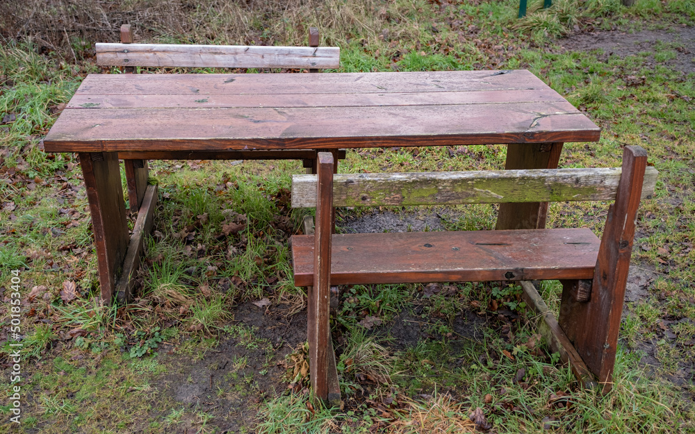 Close up of a wooden picnic table with space for wheelchair and disabled access Close up of a wooden picnic table with space for wheelchair and disabled access