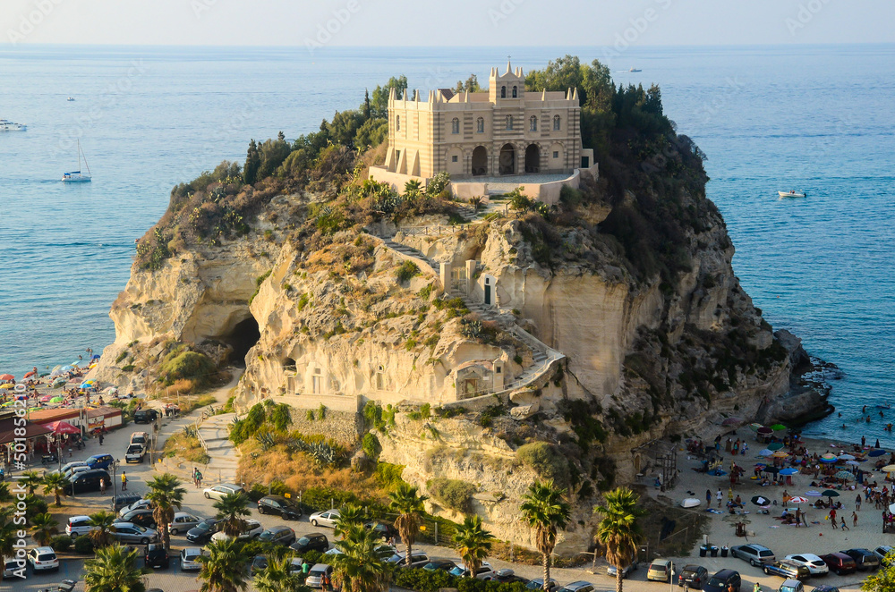Aerial view of Tropea beaches and coastline with the former 4th century monastery on top of the Sanctuary of Santa Maria of the Island, on a rocky promontory with cliffs on the Tyrrhenian sea.
