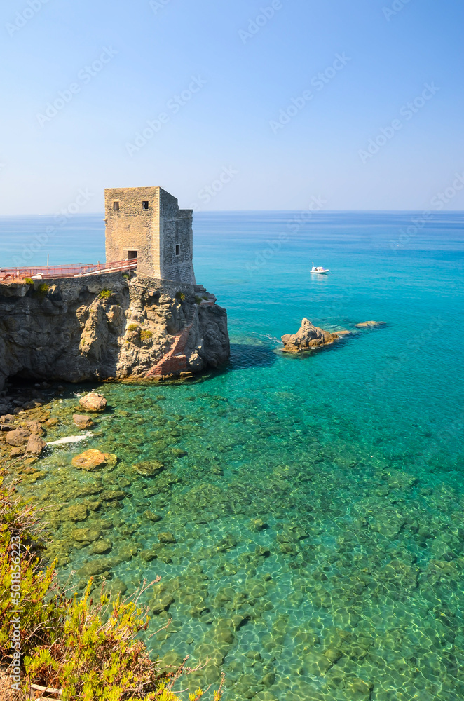 Torre delle Ciavole, a medieval guard watchtower on the rocky northern Sicilian coast with crystal clear sea water near Gliaca di Piraino, between Brolo and Gioiosa Marea.
