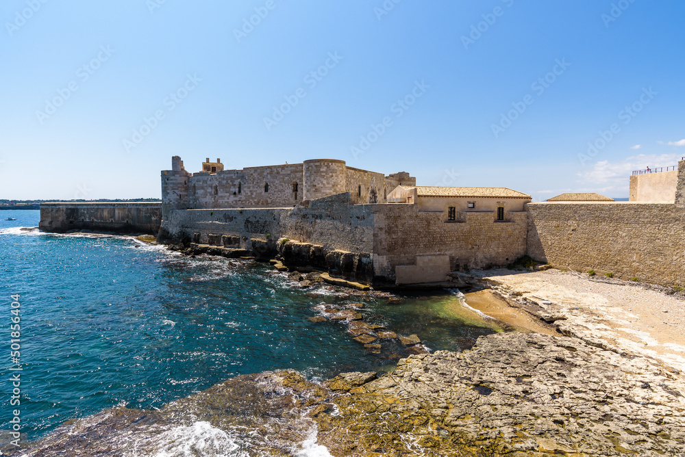 The Maniace Castle in the island of Ortigia. It was built during the Swabian period by Emperor Frederick II of Swabia. It features a decorated portal, arches, towers, a banquet room and a lighthouse.