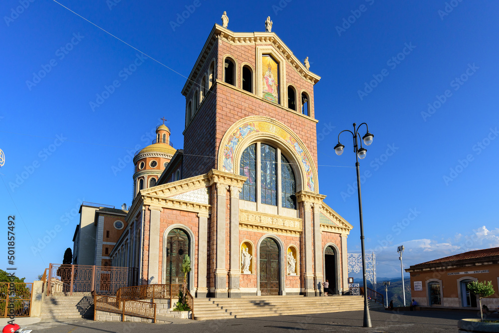 Obraz premium Facade and dome of the Tindari Sanctuary, built on a cliff with sheer drop on the sea and panoramic views of the Aeolian Islands and the gulf of Patti. The church hosts a statue of the Black Madonna. 