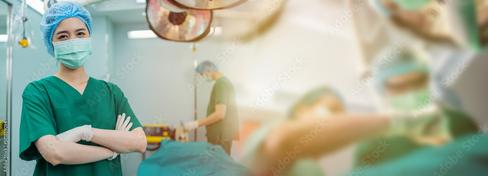 Portrait of Asian women surgeon and nurse with medical mask standing with arms crossed in operation theater at a hospital. Team of Professional surgeons. Healthcare, emergency medical service concept - obrazy, fototapety, plakaty 