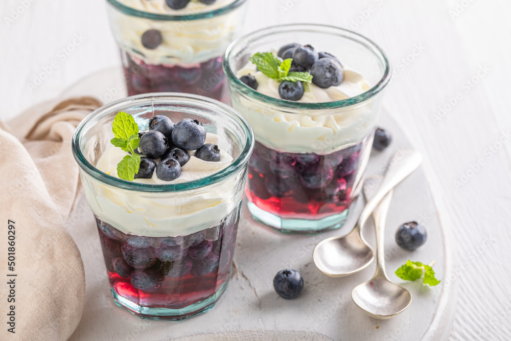 Homemade blue jelly with raw blueberries and whipped cream. Homemade blue jelly with raw blueberries and whipped cream.