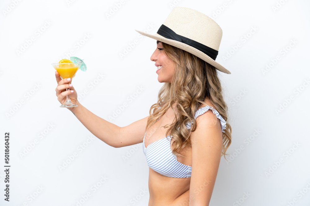 Young woman holding cocktail and wearing a bikini isolated on white background with happy expression Young woman holding cocktail and wearing a bikini isolated on white background with happy expression