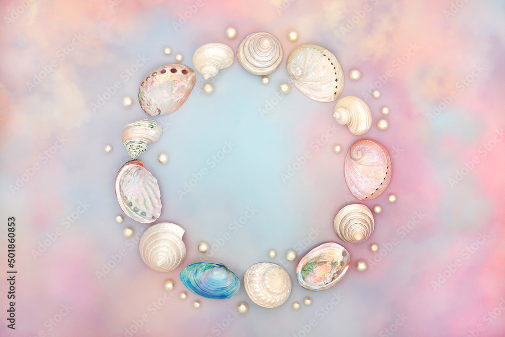 Sea shell wreath with oyster pearls on rainbow coloured cloud and sky background. Ethereal heavenly nature concept for birthday, birth of child, anniversary or holiday greetings card. Top view. Sea shell wreath with oyster pearls on rainbow coloured cloud and sky background. Ethereal heavenly nature concept for birthday, birth of child, anniversary or holiday greetings card. Top view.