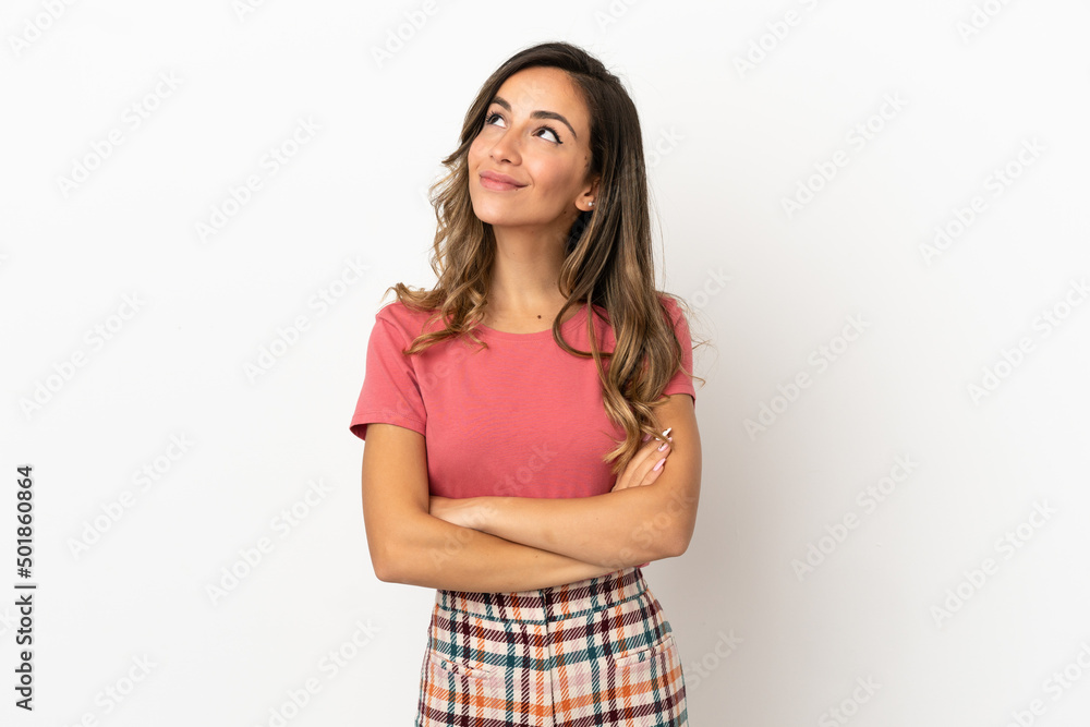 Young woman over isolated background looking up while smiling Young woman over isolated background looking up while smiling