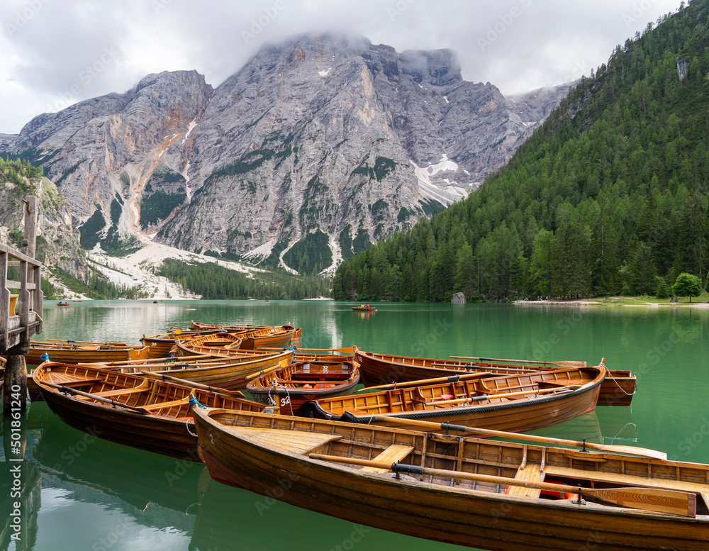 Braies Lake, Italy. Group of the traditional rowing boats made of wood. Alpine lake. Iconic location for photographers. Picturesque mountain lake in Dolomites. Wonderful nature contest