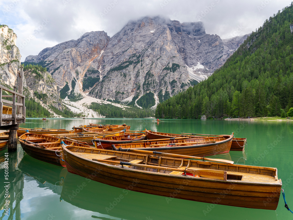 Braies Lake, Italy. Group of the traditional rowing boats made of wood. Alpine lake. Iconic location for photographers. Picturesque mountain lake in Dolomites. Wonderful nature contest