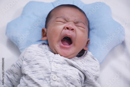 New born baby boy crying with eyes closed