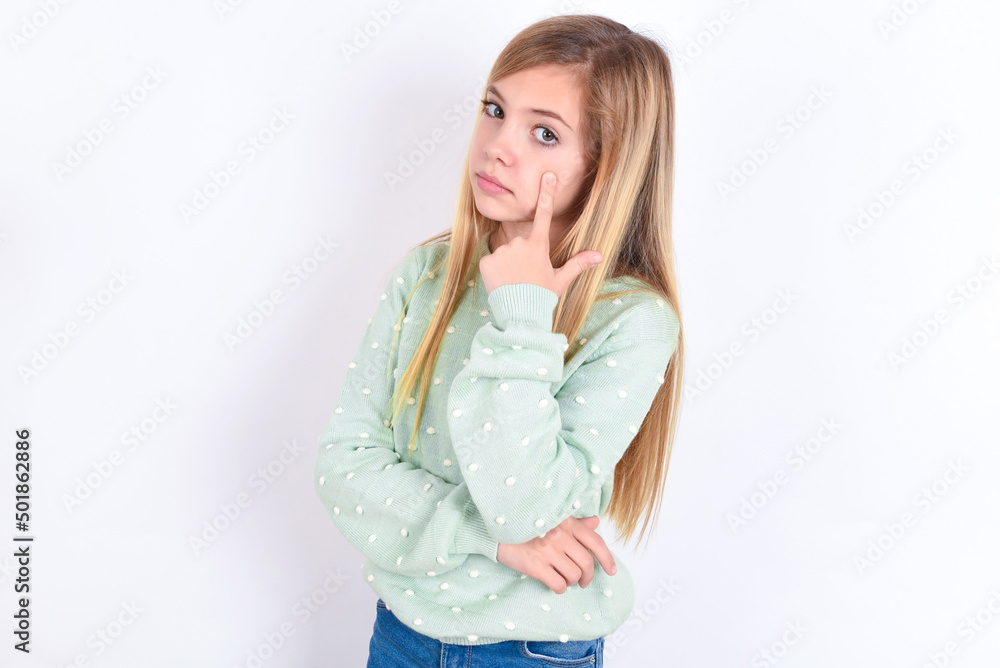 little caucasian kid girl wearing fashion sweater over blue background Pointing to the eye watching you gesture, suspicious expression. little caucasian kid girl wearing fashion sweater over blue background Pointing to the eye watching you gesture, suspicious expression.