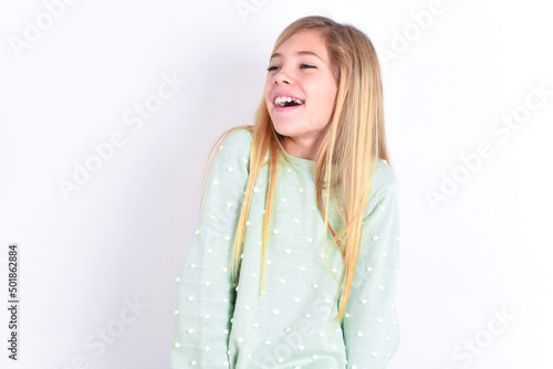 little caucasian kid girl wearing fashion sweater over blue background very happy and excited about new plans.