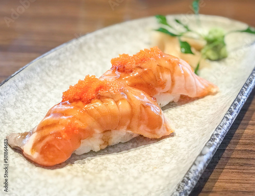 grilled salmon sushi with tobiko, shrimp eggs on top