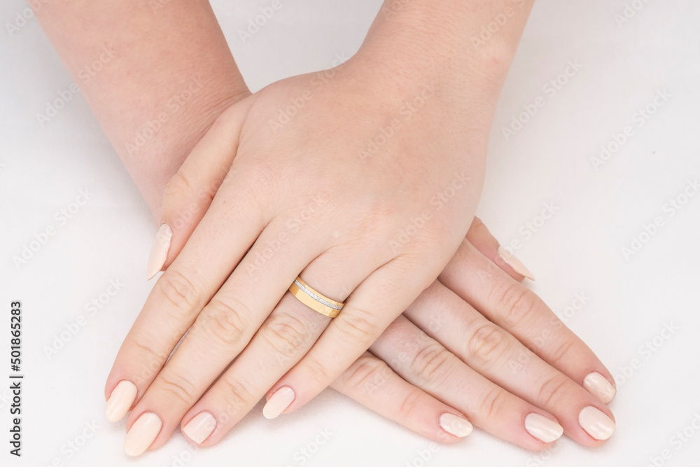 Golden Ring on a female hand, diamonds Diamond ring in hands of young lady. Close-up photo shoot Golden Ring on a female hand, diamonds Diamond ring in hands of young lady. Close-up photo shoot
