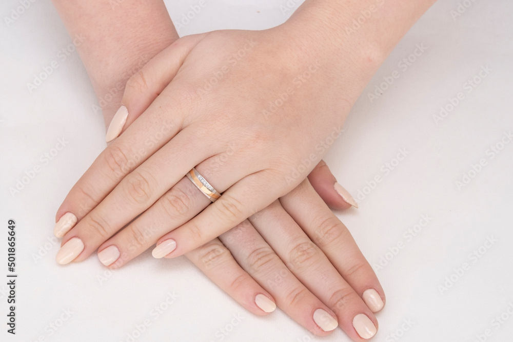 Golden Ring on a female hand, diamonds Diamond ring in hands of young lady. Close-up photo shoot Golden Ring on a female hand, diamonds Diamond ring in hands of young lady. Close-up photo shoot