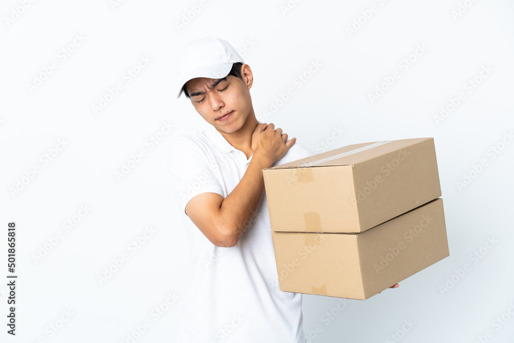 Delivery Chinese man isolated on white background suffering from pain in shoulder for having made an effort Delivery Chinese man isolated on white background suffering from pain in shoulder for having made an effort