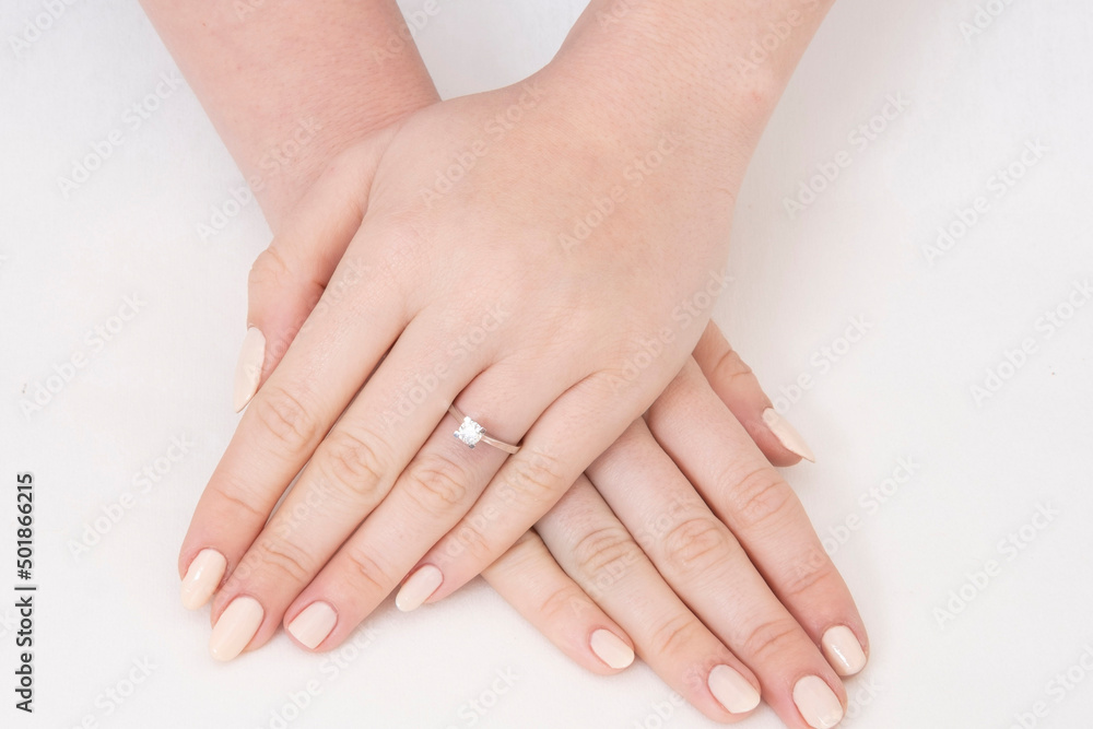 Golden Ring on a female hand, diamonds Diamond ring in hands of young lady. Close-up photo shoot Golden Ring on a female hand, diamonds Diamond ring in hands of young lady. Close-up photo shoot
