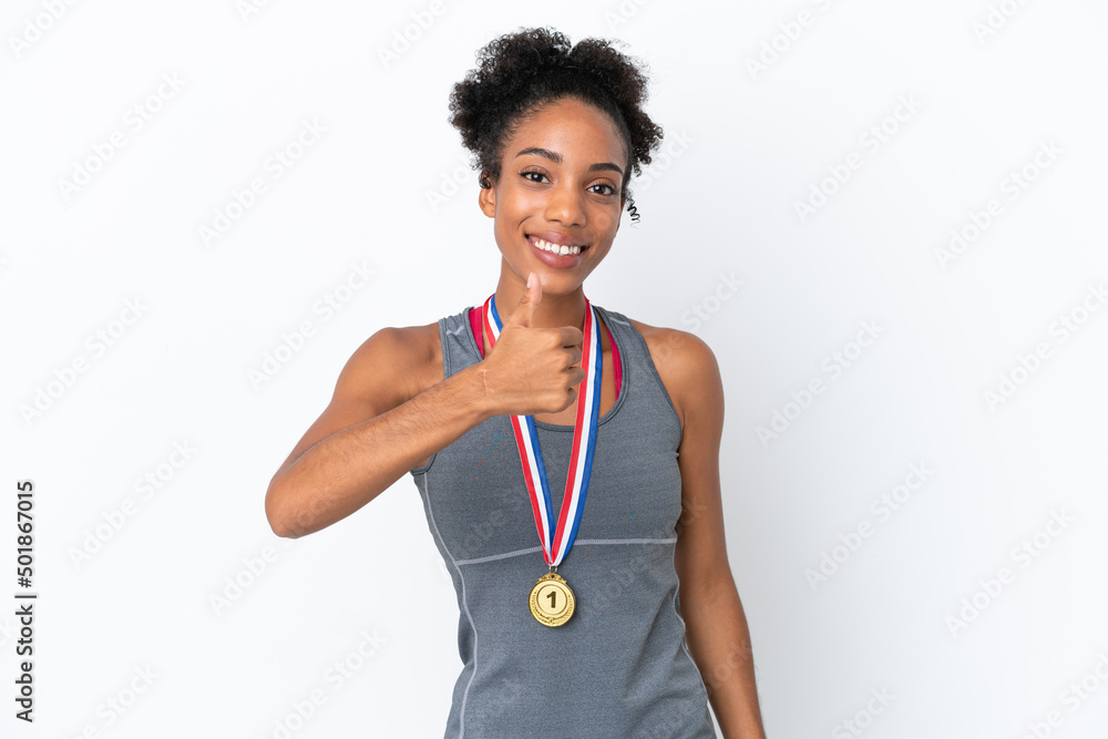 Young African American woman with medals isolated on white background giving a thumbs up gesture Young African American woman with medals isolated on white background giving a thumbs up gesture