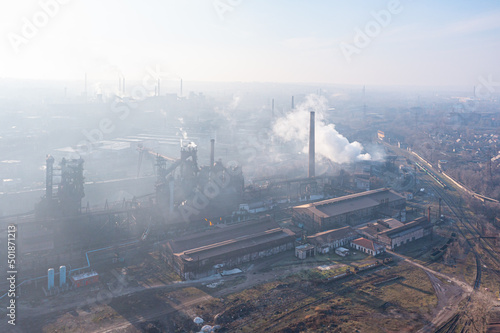 Big old metallurgical plant. Tall chimneys and blast furnaces. A lot of smoke. Aerial view.
