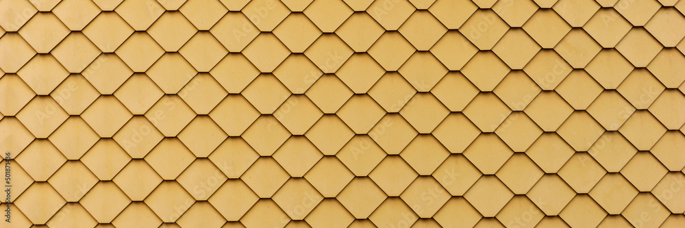 New yellow slate facade background. Slate facade texture. Panoramic image New yellow slate facade background. Slate facade texture. Panoramic image