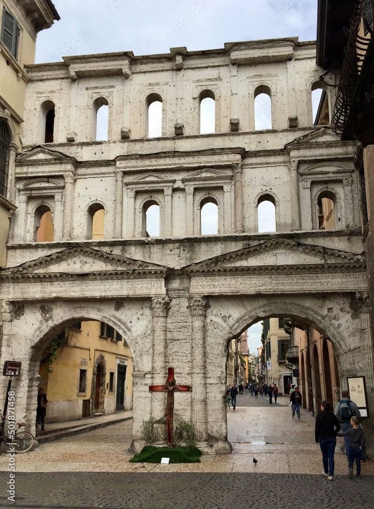 Verona, Italy. Porta Borsari (Roman gate). The ancient Porta Borsari (Roman gate) 1st century A.D. Verona (UNESCO world heritage site). View from Corso Cavour. Selective focus. Vertical