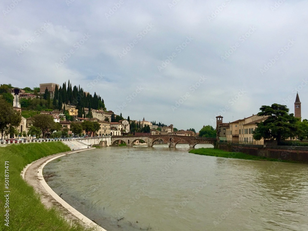 Verona, Italy. Ponte Pietra bridge, a historical Roman arch bridge, across the Adige river.
