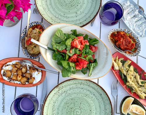 Mediterranean Turkish summer food. Collection of traditional mezes or appetizers on white table. Directly above. Dinner or lunch photo