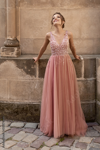 Billede på lærred Portrait of beauiful European girl bridesmaid in classic pink dress