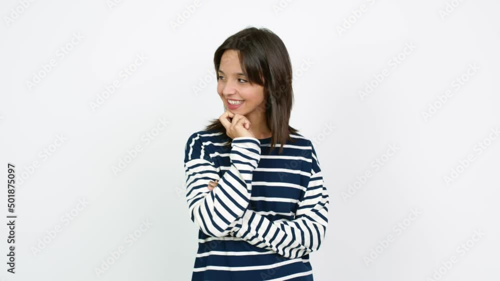 Young brunette woman standing and looking to the side over isolated background Young brunette woman standing and looking to the side over isolated background