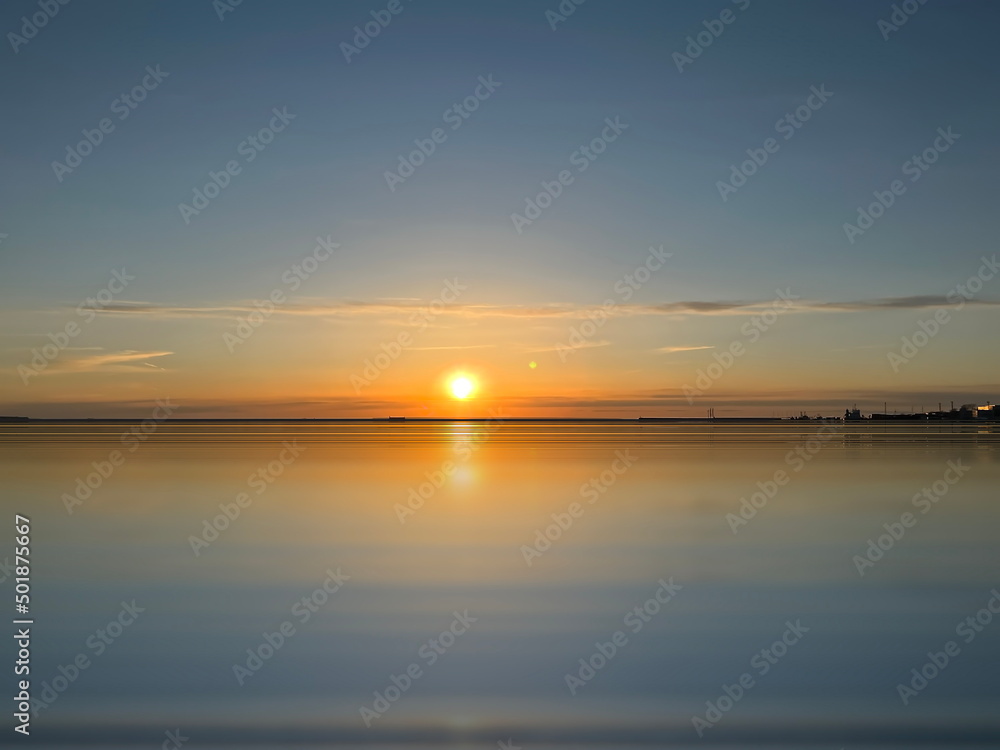 sunset at Baltic sea sun beam and light reflection on water background travel to Estonia
