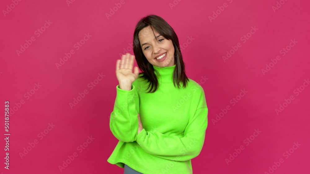 Young brunette woman saluting with hand with happy expression over isolated background Young brunette woman saluting with hand with happy expression over isolated background