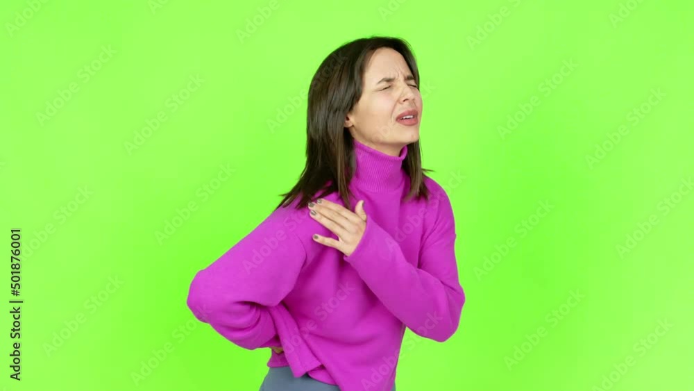 Young brunette woman suffering from pain in shoulder for having made an effort over isolated background. Green screen chroma key Young brunette woman suffering from pain in shoulder for having made an effort over isolated background. Green screen chroma key