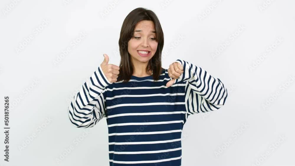 Young brunette woman making good-bad sign over isolated background Young brunette woman making good-bad sign over isolated background