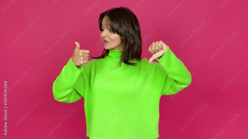 Young brunette woman making good-bad sign over isolated background Young brunette woman making good-bad sign over isolated background