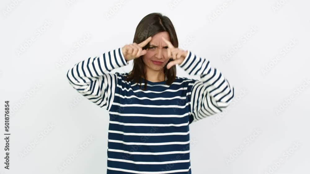 Young brunette woman focusing with fingers over isolated background Young brunette woman focusing with fingers over isolated background