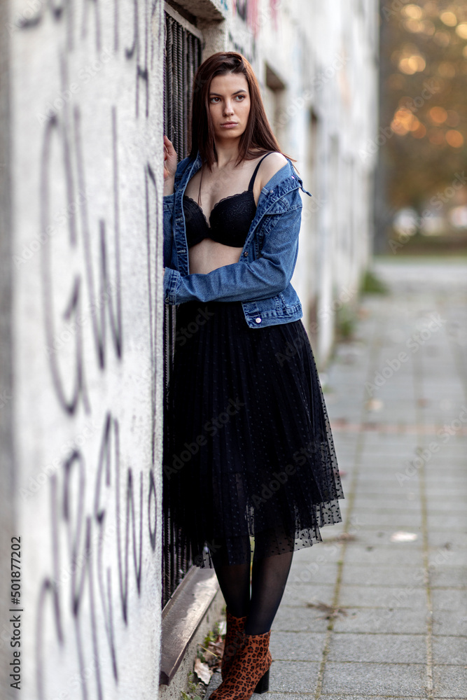 Beautiful young woman portrait in urban part of city