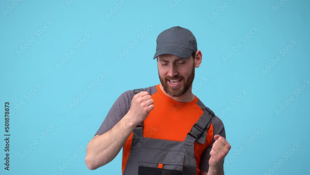 Engineer in uniform rejoices and dancing at the successful completion of project on blue background Engineer in uniform rejoices and dancing at the successful completion of project on blue background