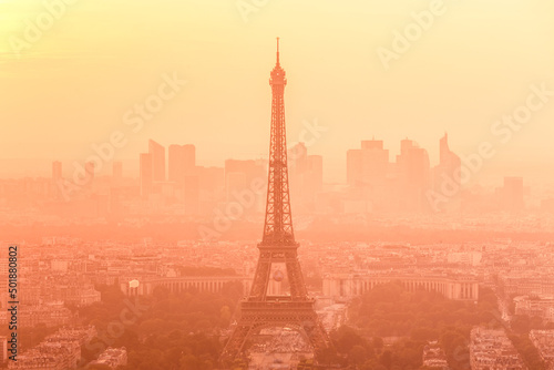 Aerial view of Paris with Eiffel tower and major business district of La Defence in background at sunset