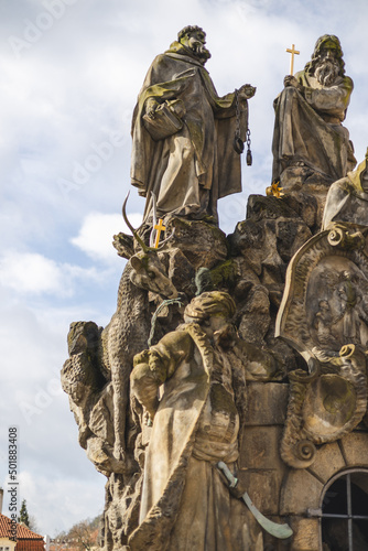 fragment of Baroque sculpture of John of Matha, Felix of Valois and Saint Ivan on the Charles Bridge, Prague, Czech Republic photo