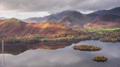 Beautiful landscape Autumn image of view from Walla Crag in Lake District, over Derwentwater looking towards Catbells and distant mountains with stunning Fall colors and light photo