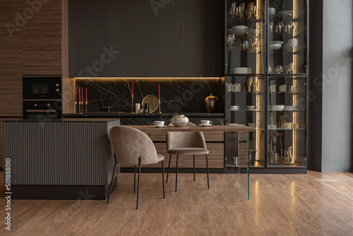 kitchen veiw of a chic modern design of a dark expensive interior of a luxurious country house with huge panoramic windows and a magnificent view of the divine forest