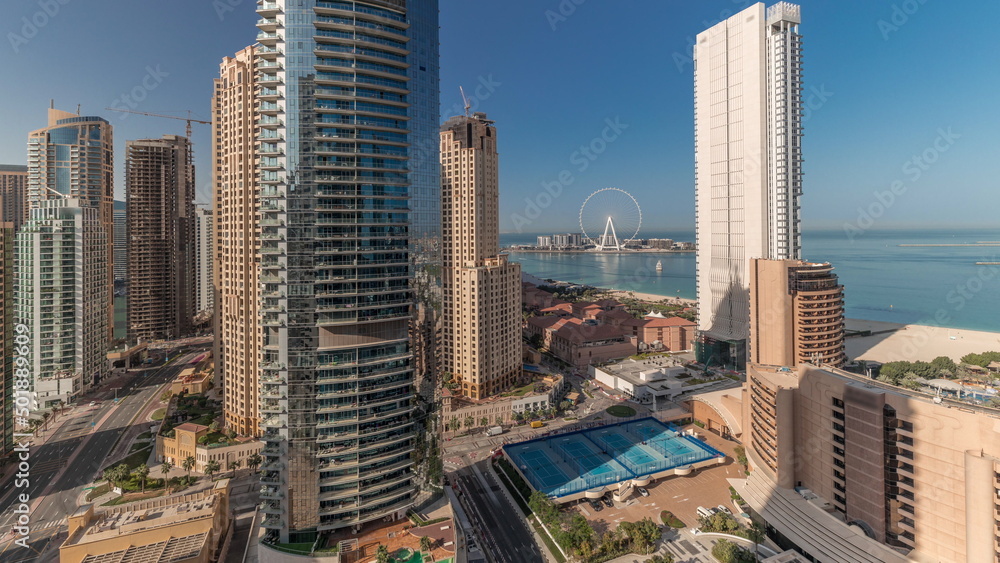 Obraz premium Panoramic view of the Dubai Marina and JBR area and the famous Ferris Wheel aerial timelapse